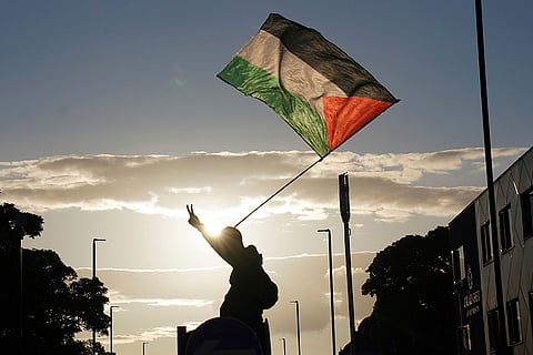 Anti-racism protesters waves a Palestinian flag in Newcastle